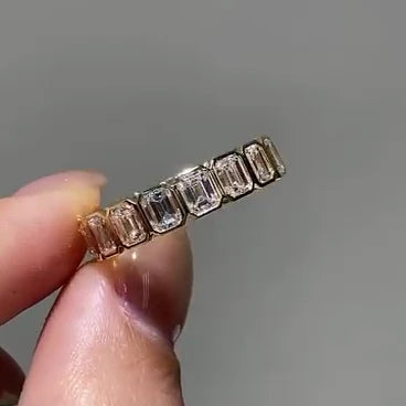 exquisite emrald bezel set eternity ring